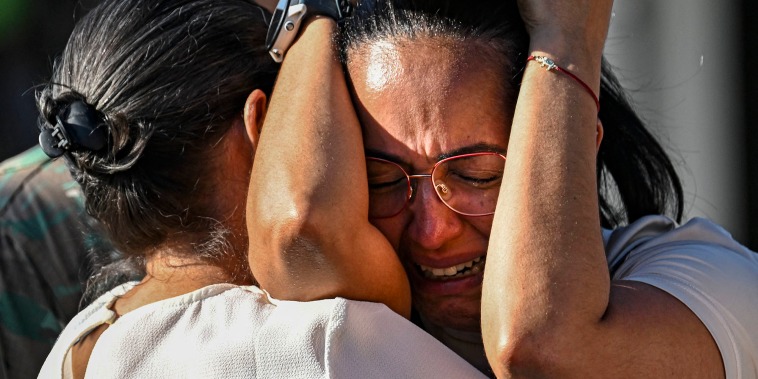 A woman cries outside of the Jet Set nightclub