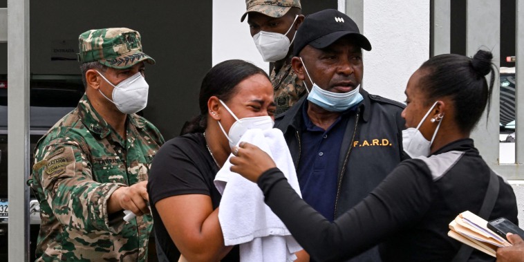 A woman cries as she leaves the Forensic National Institute morgue.