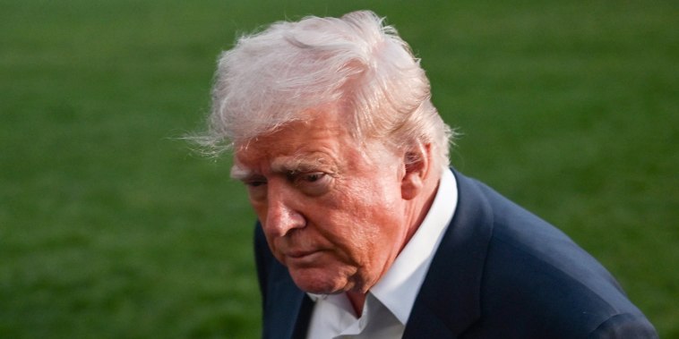 President Donald Trump leaves after taking questions from reporters