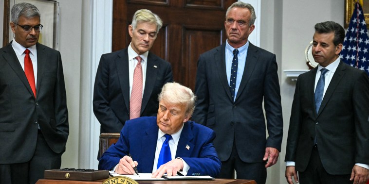 Image: President Donald Trump signs an executive order on prescription drug prices