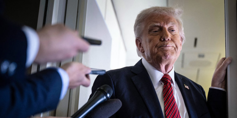 President Donald Trump listens to questions 