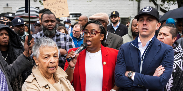 Rep. LaMonica McIver speaking in the middle of a crowd.