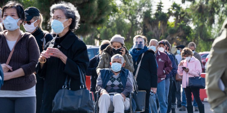 People wait in line to get the vaccine.