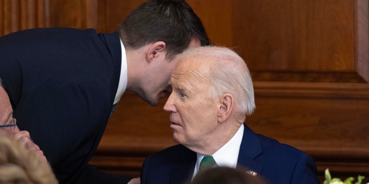 Jacob Spreyer, personal aide, speaks to the president during the annual Friends Of Ireland Speaker Luncheon at the Capitol on March 15, 2023.