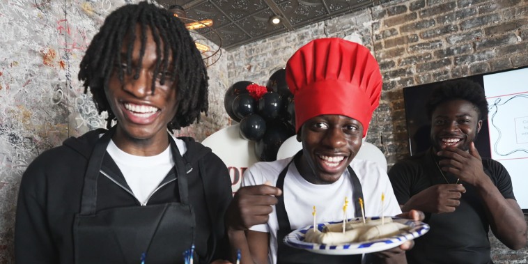 Members of OSB laughing while holding nems during a cooking class.