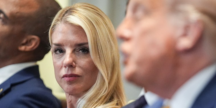 Pam Bondi, left, listens as President Donald Trump speaks