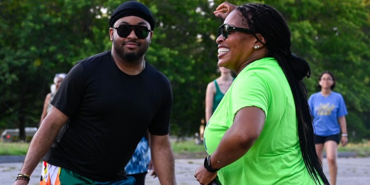 A mother and son at a line dance class in Boston's Franklin Park on July 16, 2025. The Boston Rhythm Riders host classes to boost the visibility of line dancing and its cultural significance.