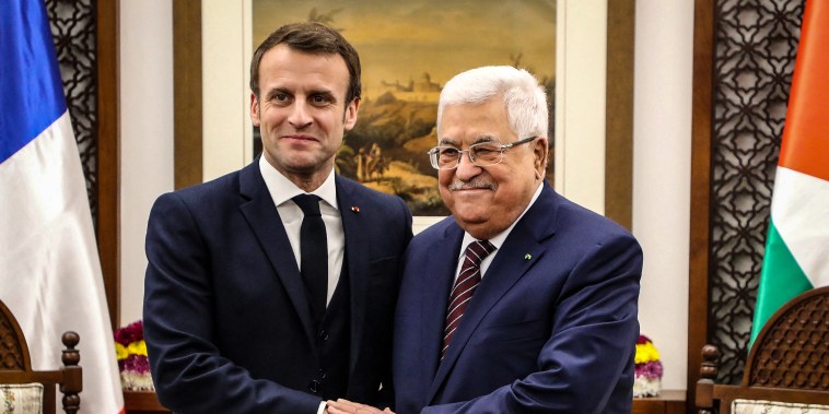 Image: French President Emmanuel Macron shakes hands with Palestinian President Mahmoud Abbas
