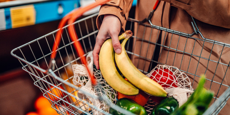 Woman shopping vegetables in supermarket.
