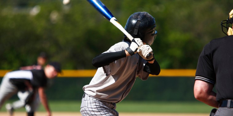 View of baseball batter from behind the catcher as they hit
