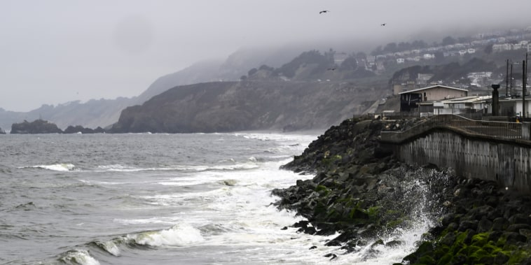 The Pacific Ocean along coastline as a wave crashes onto the land