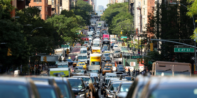 Cars and pedestrians move along the 2nd Avenue in the Manhattan borough of New York City on July 29, 2025. 