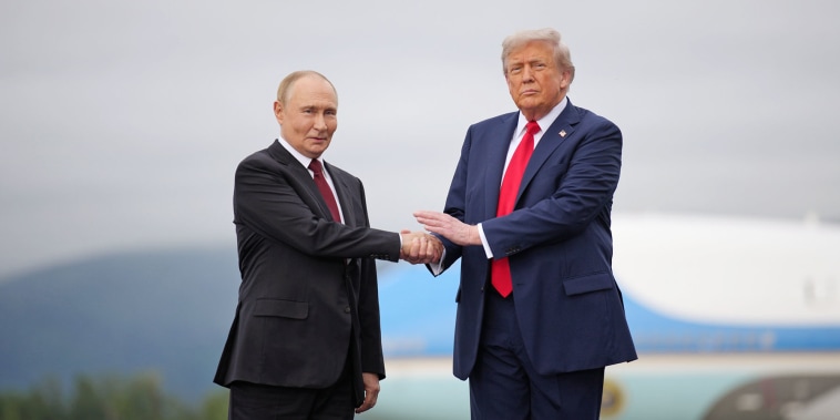 President Donald Trump greets Russian President Vladimir Putin as he arrives at Joint Base Elmendorf-Richardson on Aug. 15, 2025 in Anchorage, Alaska. 