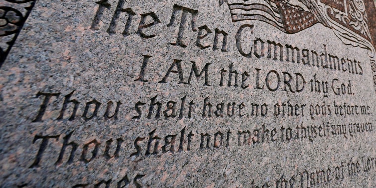 A granite Ten Commandments monument stands on the ground of the Texas Capitol