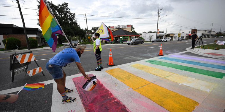 Activists rally at the Pulse Interim Memorial after repainting a rainbow-colored crosswalk on Friday, Aug. 22, 2025, in Orlando, Fla. 