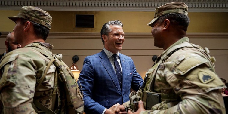 Defense Secretary Pete Hegseth greets a member of the National Guard at Union Station in Washington on Aug. 20, 2025. 
