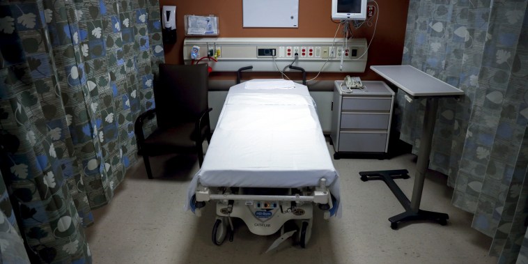 Empty hospital bed in a room