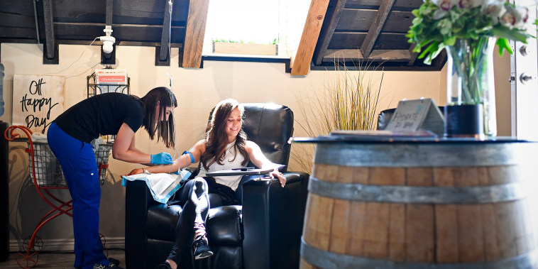 A nurse prepares a patient for an IV at Hydrate IV Bar