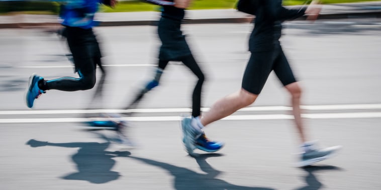 People run and shadows reflect.