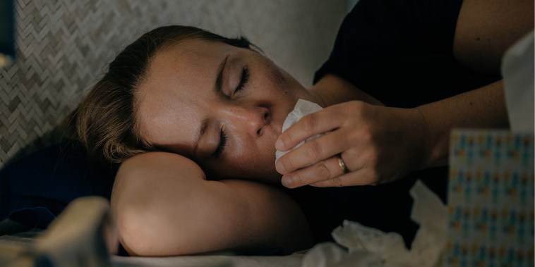 Sick woman using tissue paper at home.