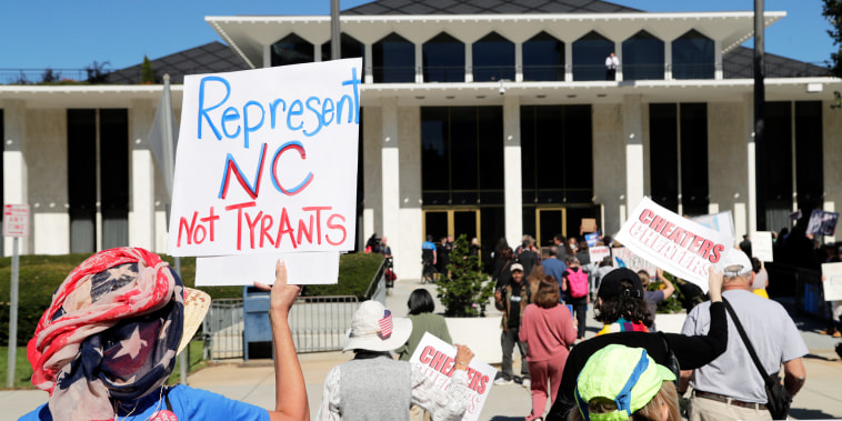 Demonstrators approach the Legislative Building during a rally protesting a proposed election redistricting map on Tuesday.