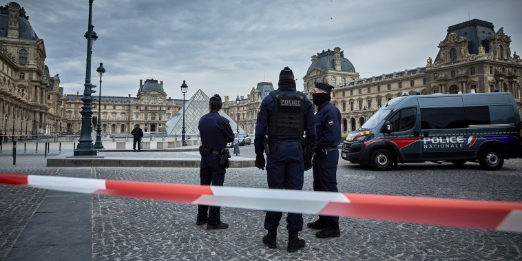 French Police officers seal off the entrance to the Louvre Museum after a Jewllery Heist.