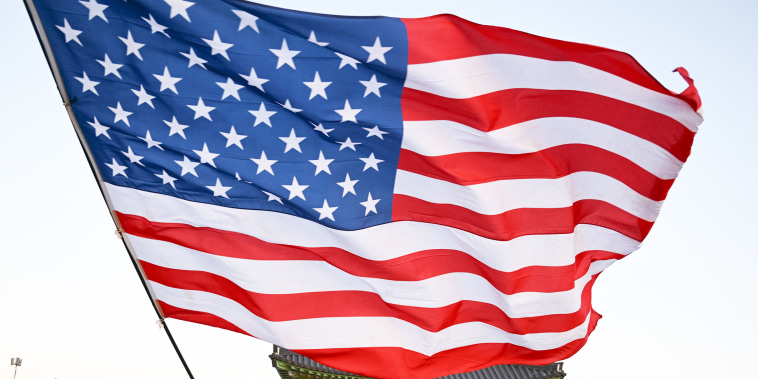 An American flag being waved during a rally. 