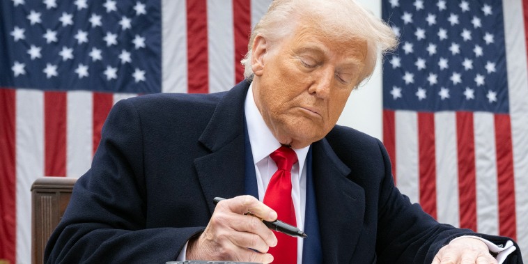 US President Donald Trump signs an executive order at the White House.