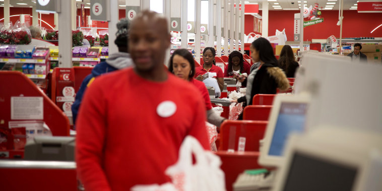 Employees ring customers up at cash registers inside a Target store in Jersey City, N.J.