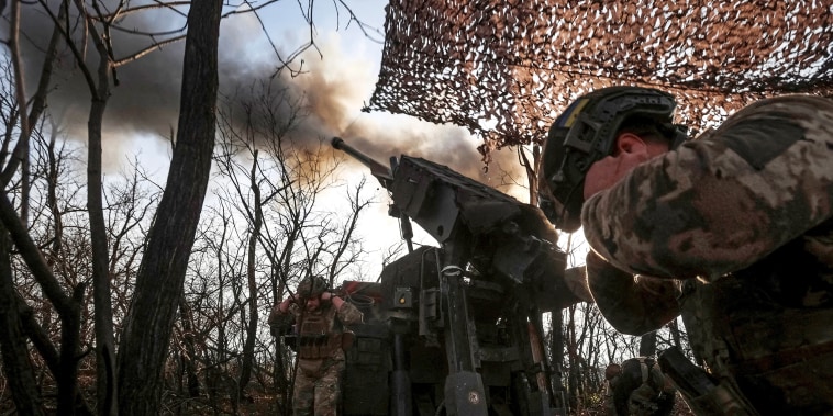 Ukrainian servicemen fire a self-propelled howitzer towards Russian troopsn near the front line town of Pokrovsk