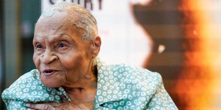 Viola Fletcher places her hand on her chest while speaking