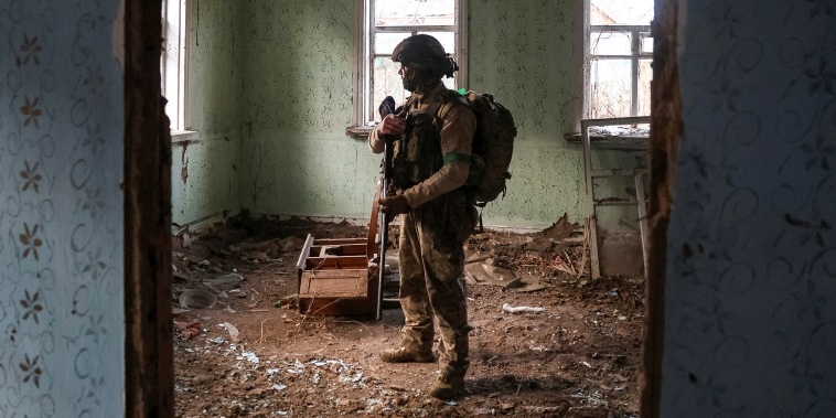 Ukrainian serviceman hides from a Russian combat drone in a building damaged by Russian military strike in the frontline town of Kostiantynivka