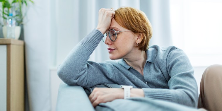 Mid adult woman with headache