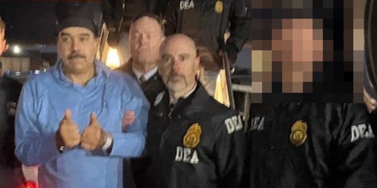 Venezuelan president Nicolas Maduro is escorted by DEA agents off of a plane