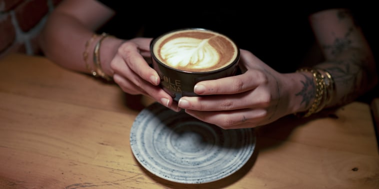 A person holding a cup of coffee
