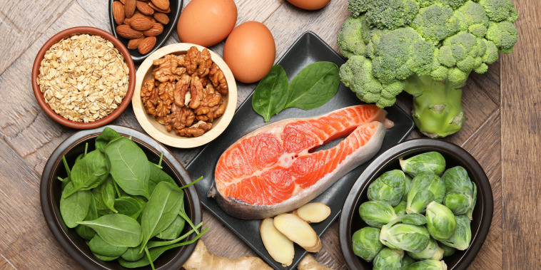 Different fresh products rich in melatonin on wooden table, flat lay