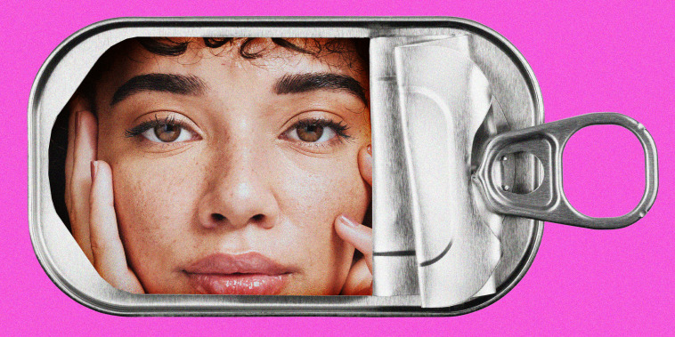 A woman's face inside an empty tin sardine can.