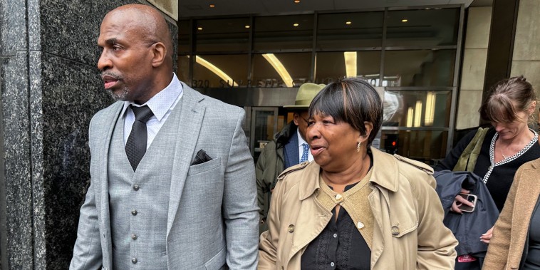 Kenneth Windley, left, leaves a courthouse with his mother, Francina Windley Patterson.