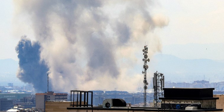 Smoke rises following strikes on Tehran on April 7, 2026.