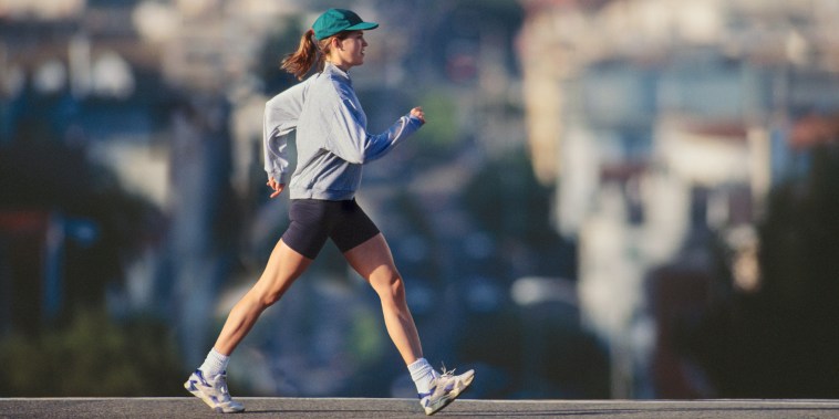 Young woman powerwalking in urban area, profile
