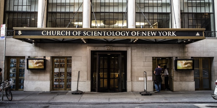 A brick building with tall windows and an awning with lettering: CHURCH OF SCIENTOLOGY OF NEW YORK.