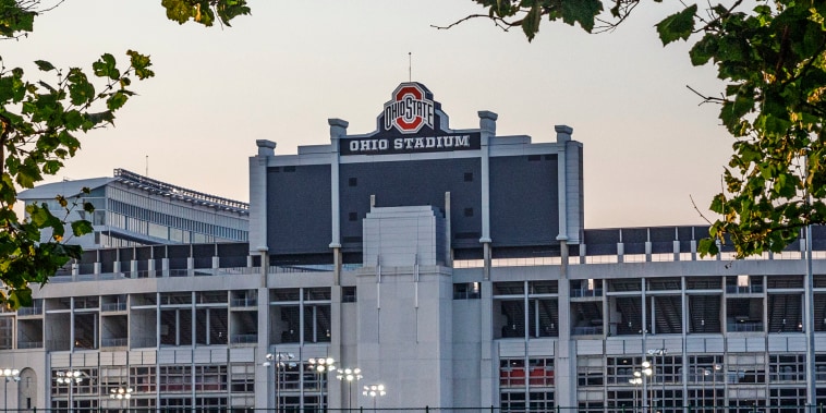 Students play soccer with the Ohio Stadium in the background