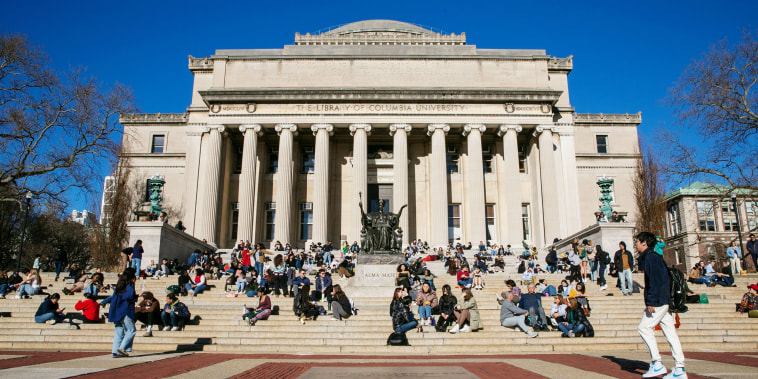 Students relax on the front steps of Low Memorial Library at Columbia University in New York in 2023. 