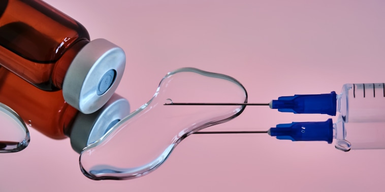 Bottles for injections and a syringe with a needle on a pink background.