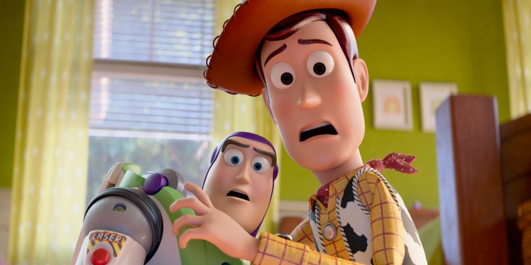 Buzz Lightyear and Woody stand next to each other in a bedroom making shocked expressions
