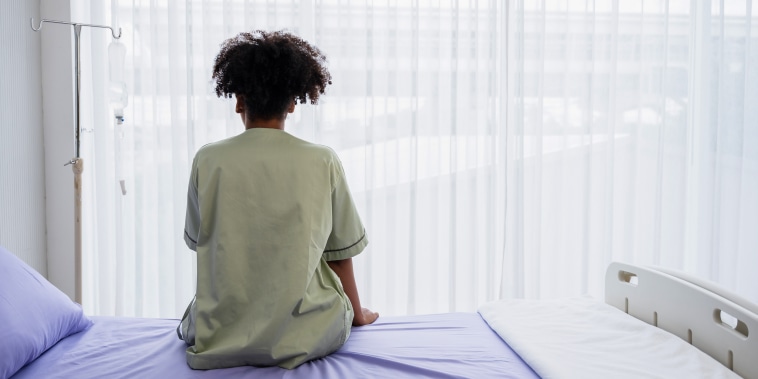 Lonely patient sitting on the hospital bed