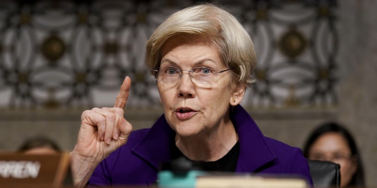 Elizabeth Warren holds one finger up while speaking during a Senate hearing.
