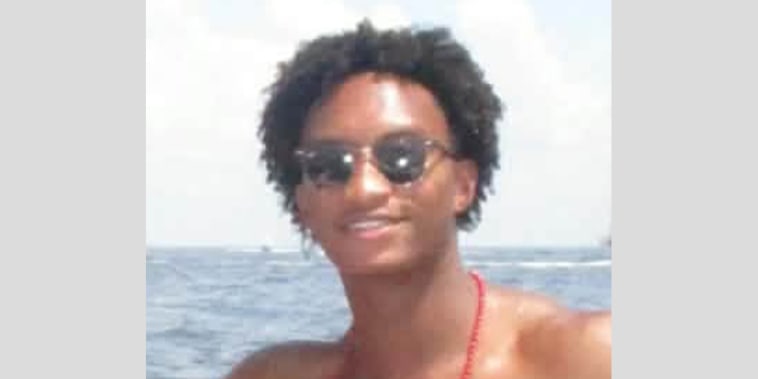 Nolan Xavier Wells outside on a boat smiling for a photo