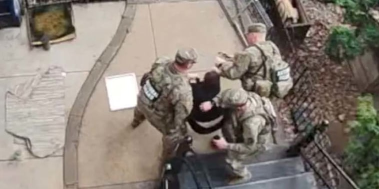 Anna King is detained by three members of the National Guard.