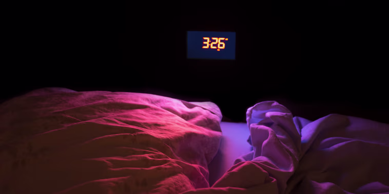 Image: The glow of an alarm clock in the middle of the night.